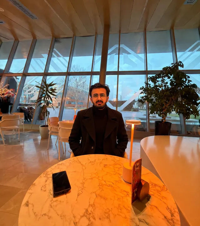 Ammar Ul Haq seated in a cafรฉ